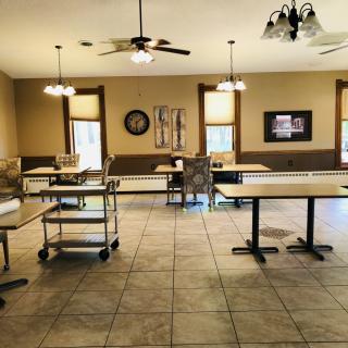 An empty dining room with tables and chairs neatly arranged.