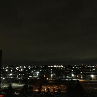 A serene night view of a city illuminated by lights against a dark sky.