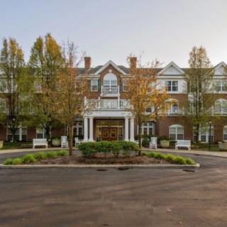 A well-maintained building with a welcoming entrance surrounded by trees and landscaping.