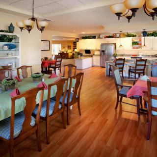 A spacious kitchen and dining area with modern decor and hardwood flooring.