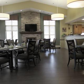 A spacious and modern dining area featuring elegant furniture and ample natural light.