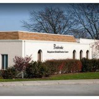 Exterior view of a healthcare facility with a brick facade.