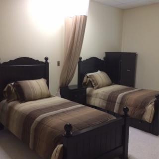 A cozy bedroom with twin beds and a warm color palette.