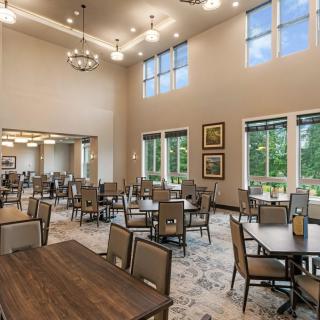 Spacious dining room with elegant decor and large windows.