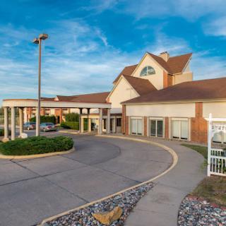 A welcoming hotel exterior with a clear blue sky.