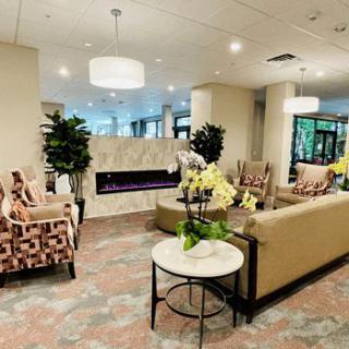 A modern lobby with comfortable seating, a fireplace, and elegant decor.