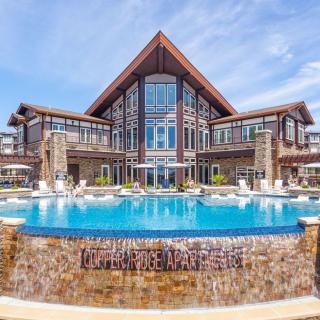 A luxurious resort featuring a stunning pool and modern architecture.