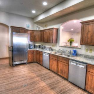 A modern kitchen with stainless steel appliances and wooden cabinets.