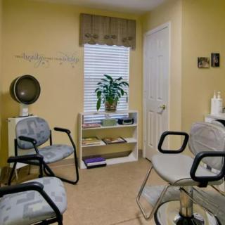 Cozy waiting room with chairs and a small plant arrangement.