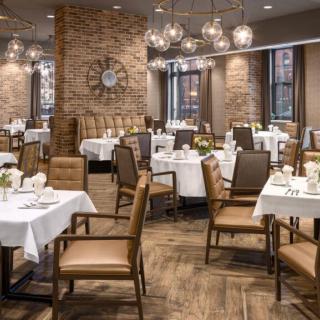 A stylish restaurant dining area with neatly arranged tables and decorative lighting.
