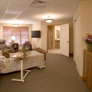 A cozy hospital room equipped with a bed, television, and patient amenities.