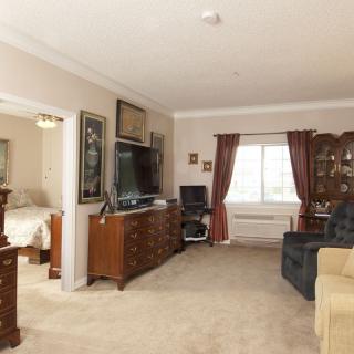 A cozy living room with a television and classic furniture.