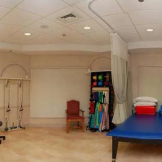 A rehabilitation room equipped with exercise and therapy tools.