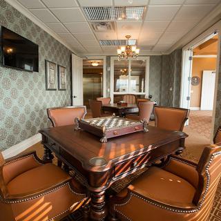 A luxurious dining room with elegant furniture and a chandelier.