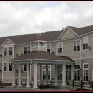 A multi-story residential building under a cloudy sky.