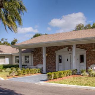 A residential building with a well-maintained garden on a sunny day.