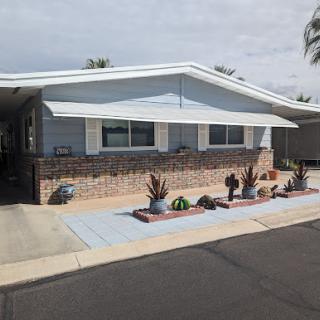 A charming residential house featuring a landscaped front yard with decorative cacti.
