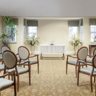 An elegantly arranged room with chairs set up for a small ceremony or event.