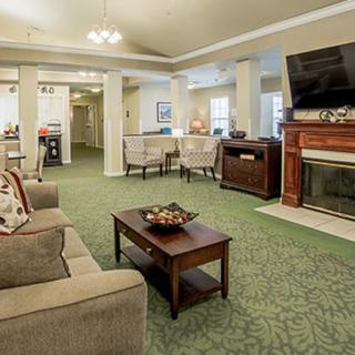 A cozy living room with a fireplace, television, and comfortable seating.