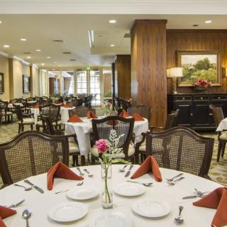 An elegant restaurant dining area with neatly arranged tables and chairs.