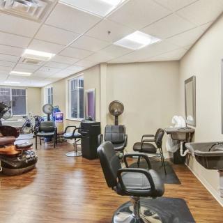 Interior of a modern hair salon with salon chairs and equipment.