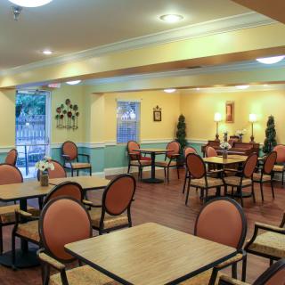 An empty dining area with neatly arranged tables and chairs.