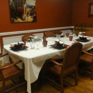 A warmly decorated dining room with a table set for dinner.