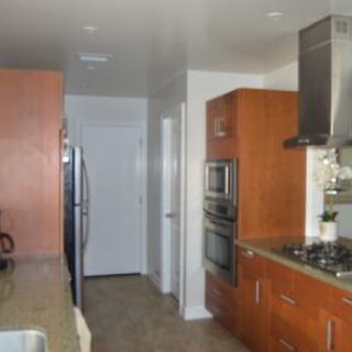 A modern kitchen with stainless steel appliances and wooden cabinets.