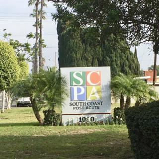 A sign for Southwest Performing Arts surrounded by greenery.