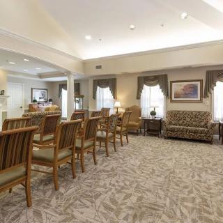 A spacious waiting room with comfortable seating and elegant decor.