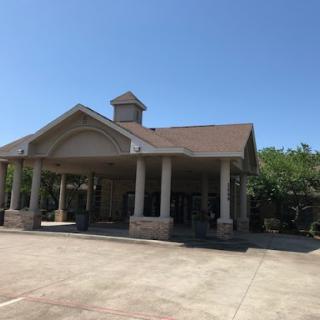 A picturesque commercial building showcasing a classic architectural design under a clear blue sky.