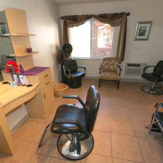 A cozy and clean hair salon interior with styling chairs and mirrors.