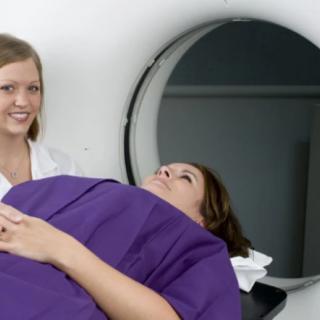 A patient undergoing an MRI scan with a healthcare professional nearby.
