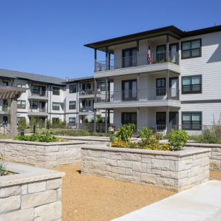 Modern apartment complex with landscaped outdoor area.