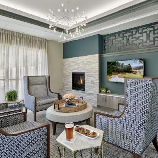 A modern and inviting living room featuring stylish furniture, a cozy fireplace, and elegant decor.