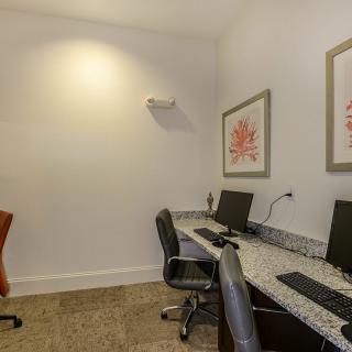 A small office space with two computer workstations and chairs.