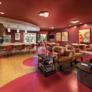 A vibrant, modern lounge with colorful decor and comfortable seating.