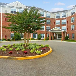 A well-maintained apartment building with landscaped entrance.