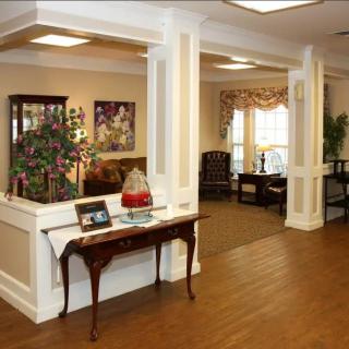 A well-furnished lobby with classic decor and wood flooring.