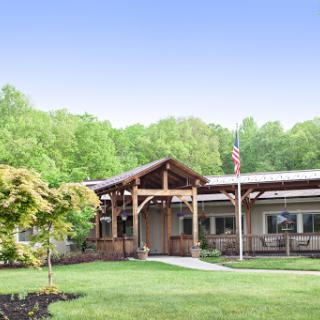 A modern home blending with nature, featuring wooden architecture and lush greenery.