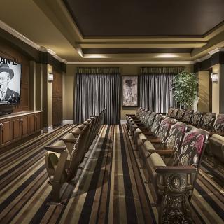 A luxurious home theater with comfortable seating and a large screen for an immersive viewing experience.