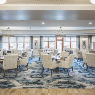 Elegant dining area with modern decor and ample natural light.