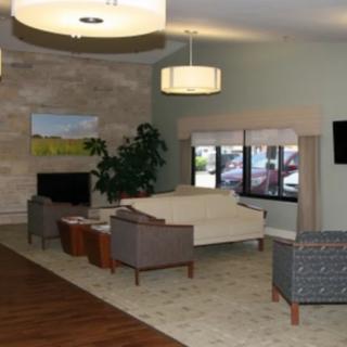 A modern living room with comfortable seating, stylish lighting, and a cozy fireplace.