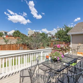 A beautiful view of a sunny patio adorned with flowers, perfect for enjoying the outdoors.