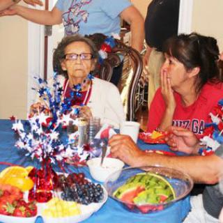 A family enjoying a festive meal with patriotic decorations.