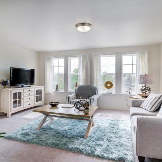 A bright and airy living room with modern furniture and a cozy atmosphere.