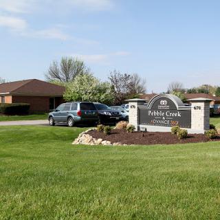 Entrance to a residential community with well-maintained landscaping.