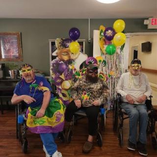Residents enjoying a vibrant Mardi Gras celebration with festive costumes and decorations.