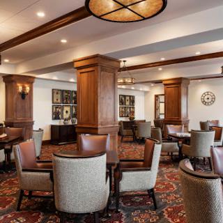 A cozy lounge area featuring elegant furniture and warm lighting.