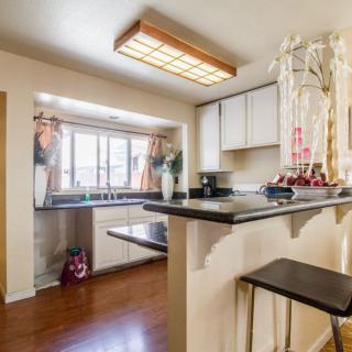 Modern kitchen interior with a countertop and stools.
